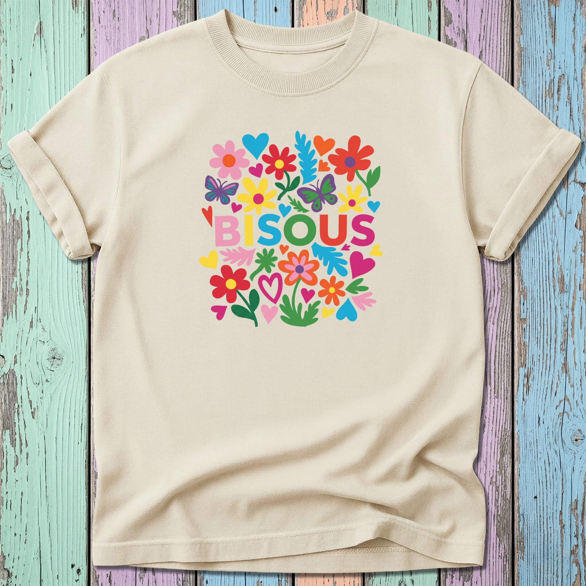 Cream t-shirt with colorful floral "BISOU" graphic.