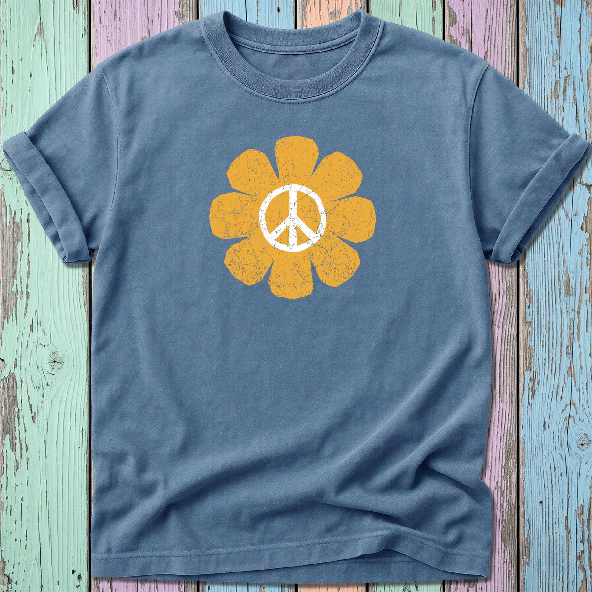 Blue t-shirt with a distressed yellow peace sign flower graphic.