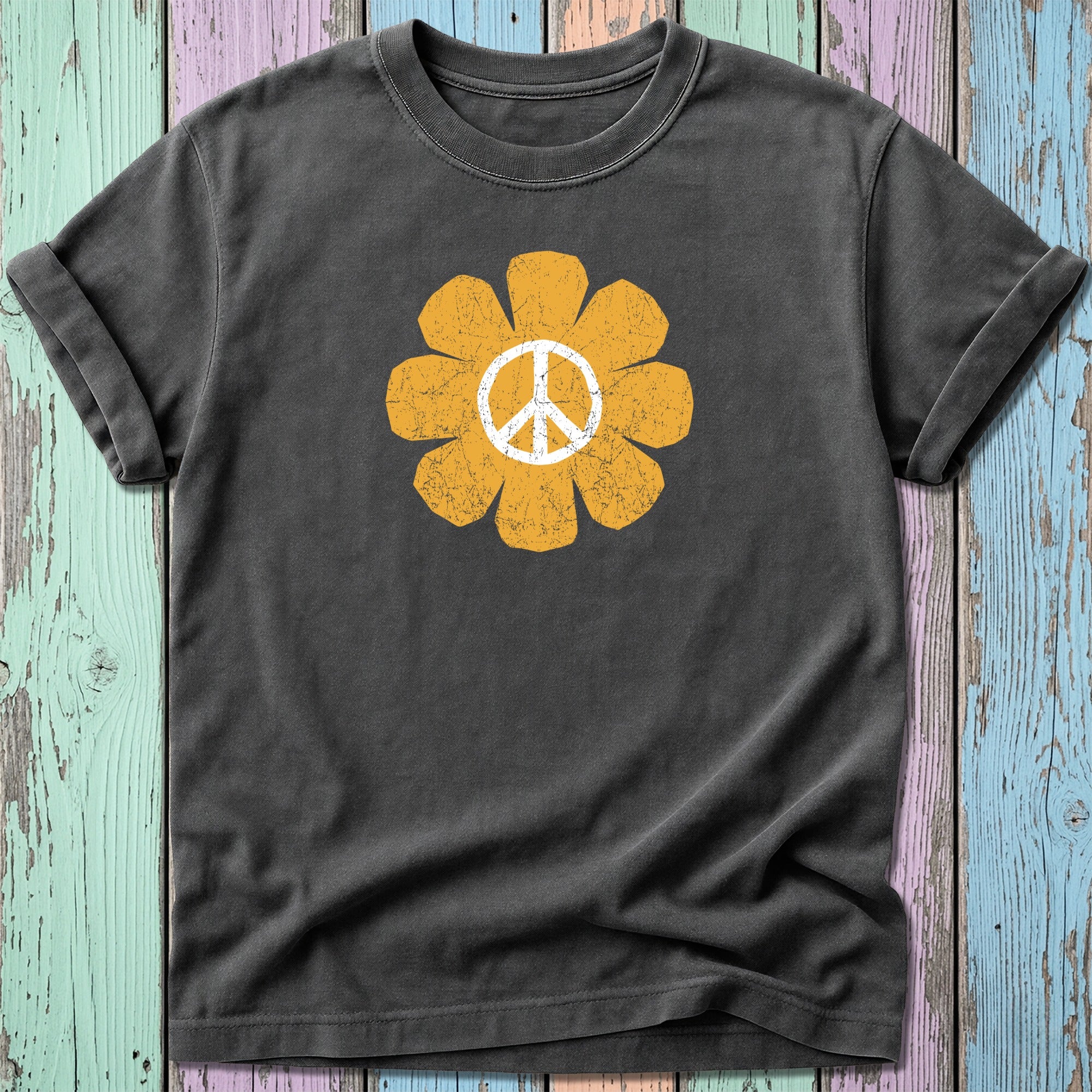 Distressed yellow peace sign flower graphic on a dark grey t-shirt.