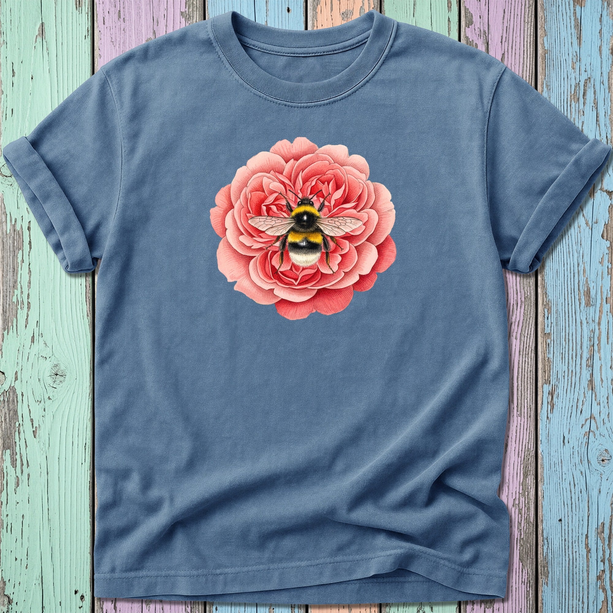 Blue t-shirt with a pink rose and bee illustration.