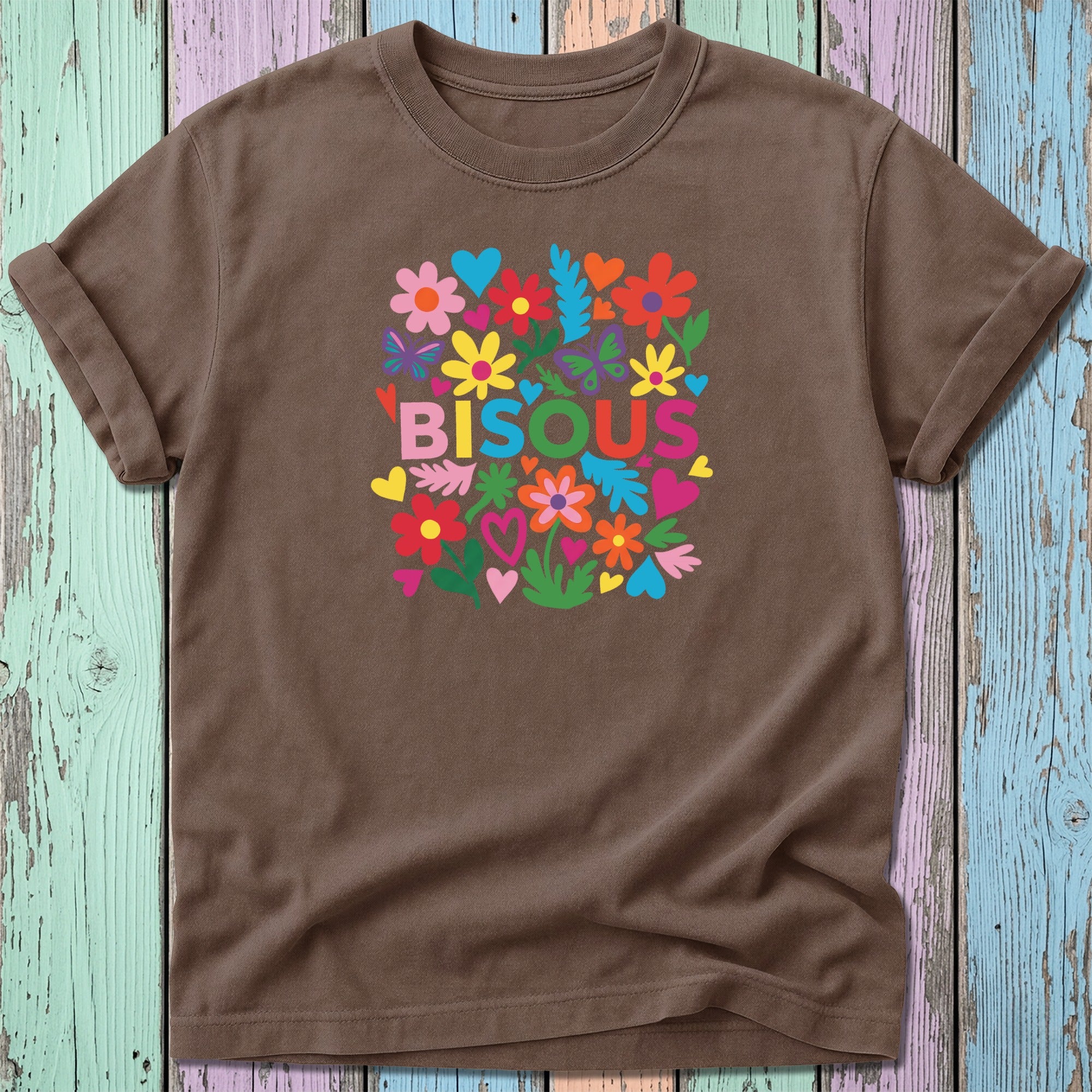 Brown t-shirt with "BISOU" text surrounded by colorful flowers and hearts.