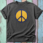Dark grey t-shirt with distressed yellow peace symbol on blue background.
