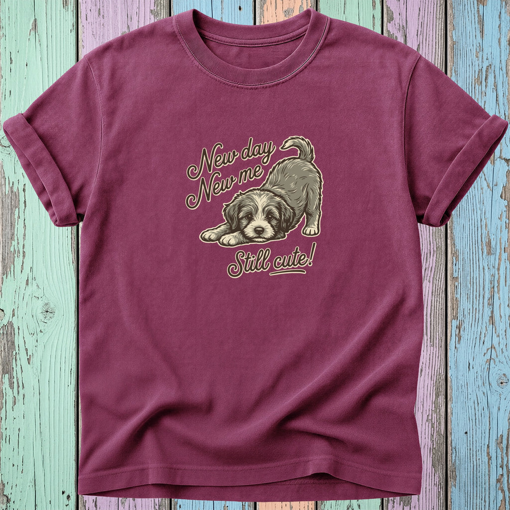 Maroon t-shirt with a drawing of a puppy and text "New day New me Still cute!".