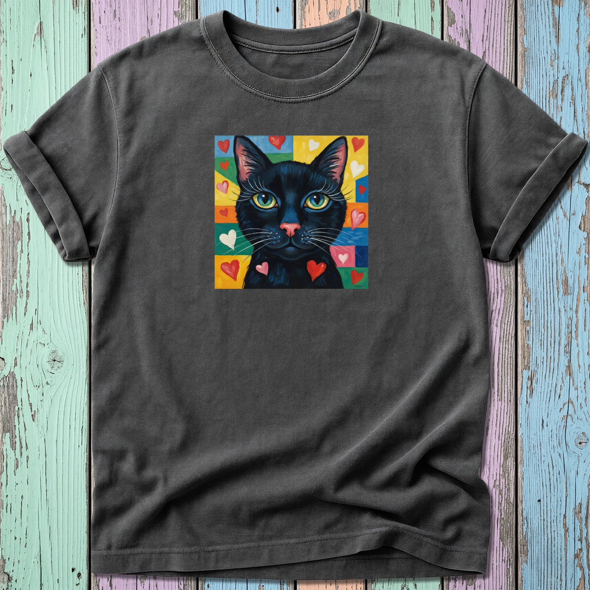 Black cat with yellow eyes on colorful background of hearts.