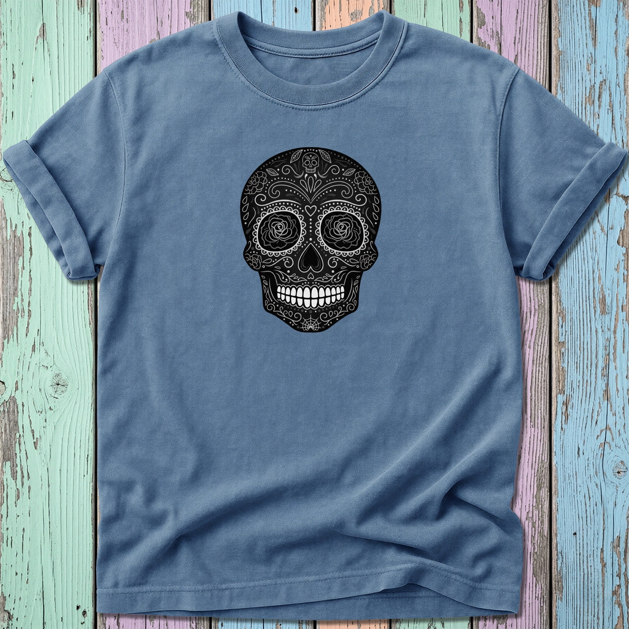 Blue t-shirt with a black and white ornate sugar skull graphic.