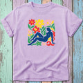 Lavender t-shirt with abstract floral and figure graphic in bright colors.