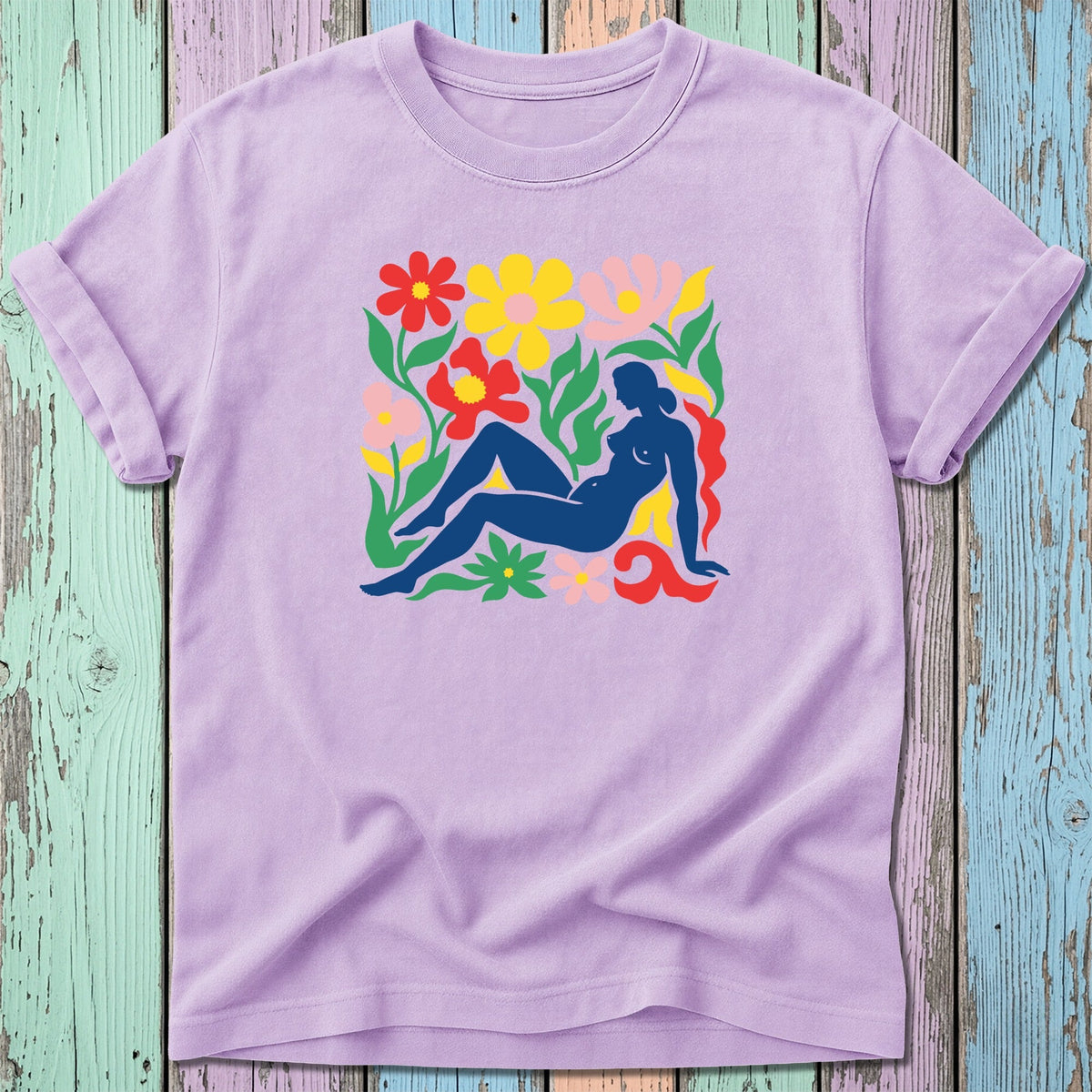 Lavender t-shirt with abstract floral and figure graphic in bright colors.
