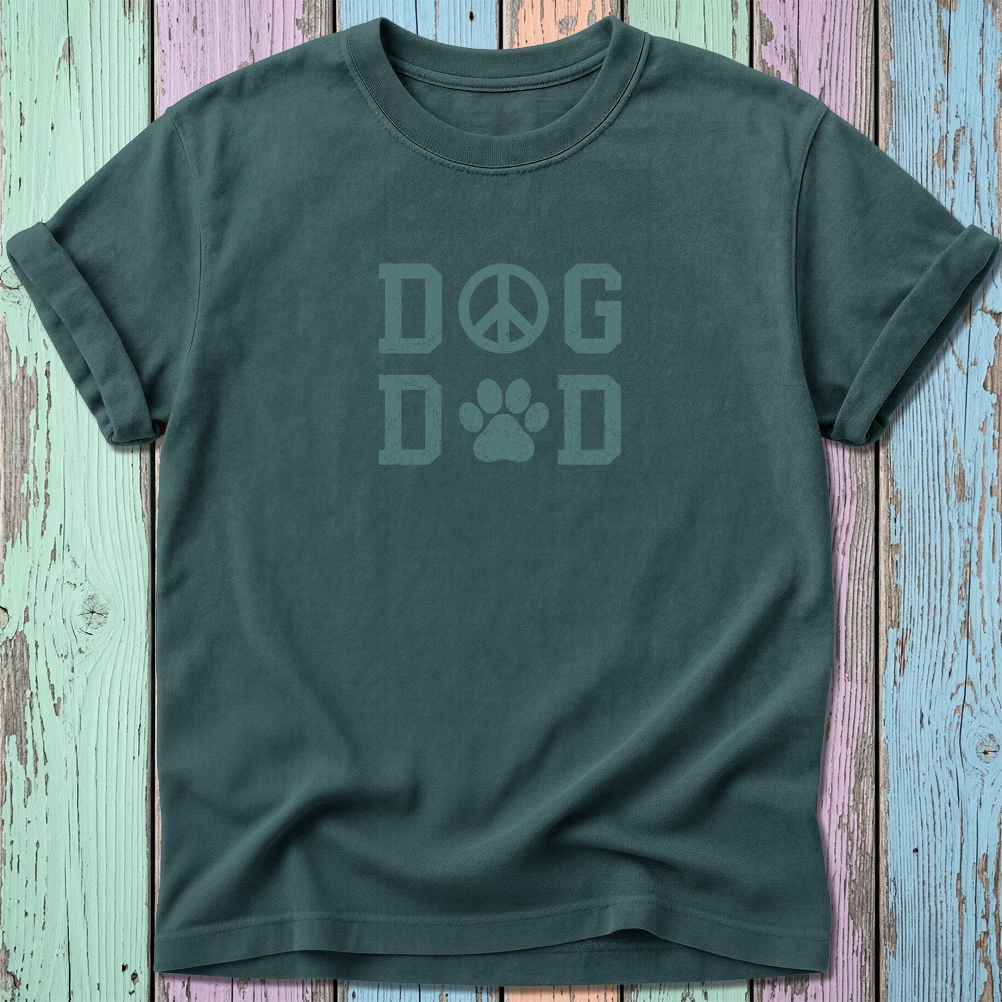 Dark green t-shirt with faded text "DOG DAD" and a peace sign and paw print.