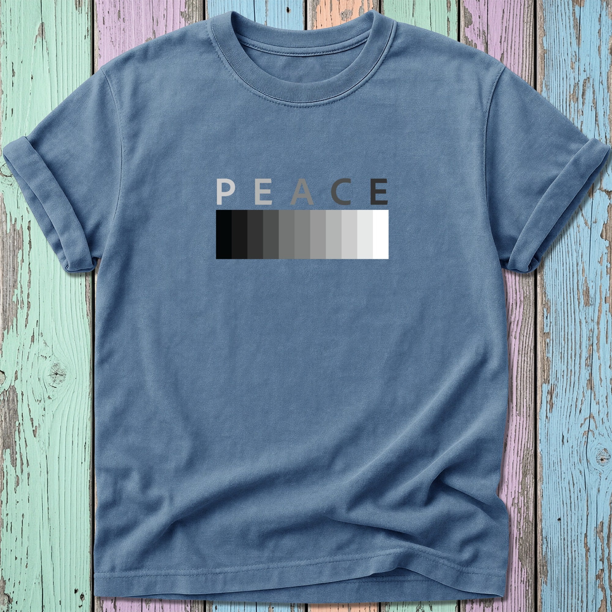 Slate blue t-shirt with "PEACE" in grayscale ombre text.