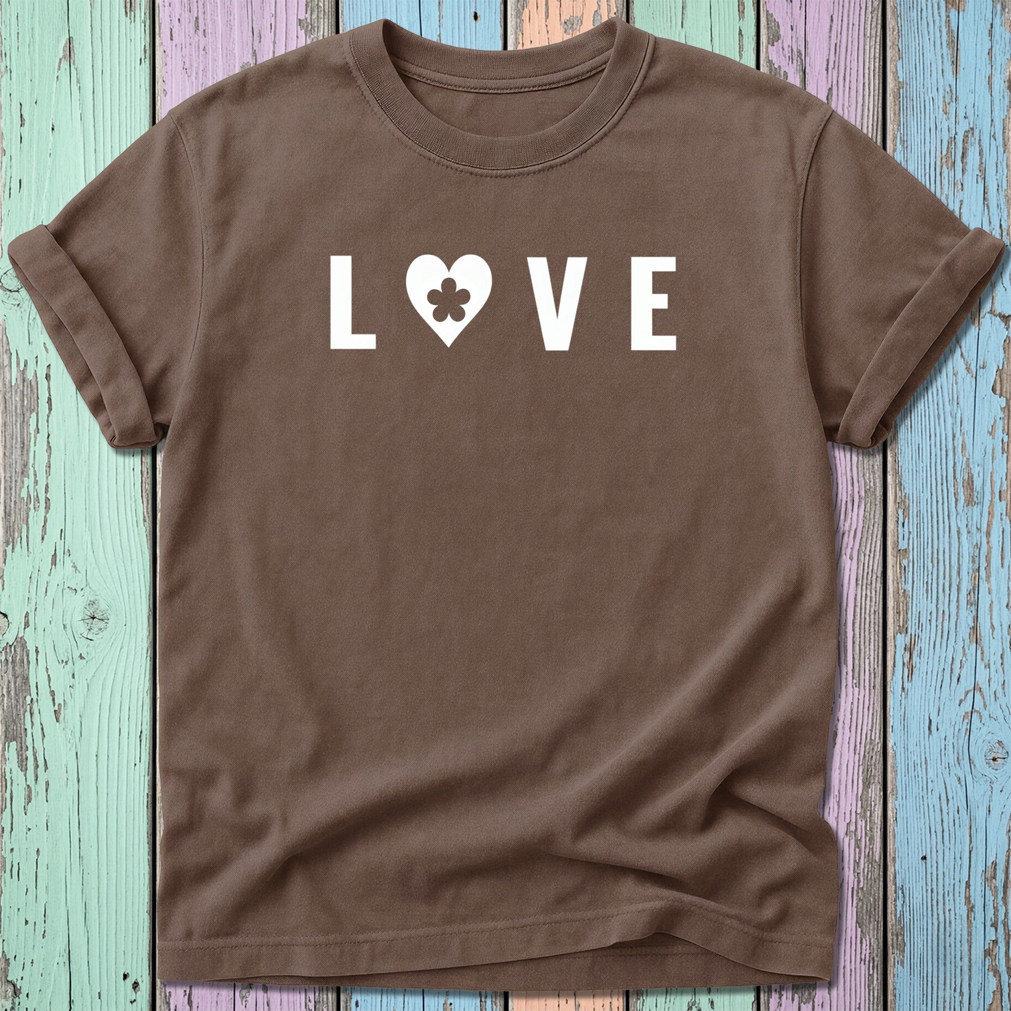 Brown t-shirt with white "LOVE" text and a heart containing a clover.