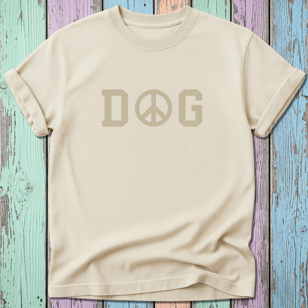 Cream t-shirt with "DOG PEACE" graphic on a colorful wooden background.