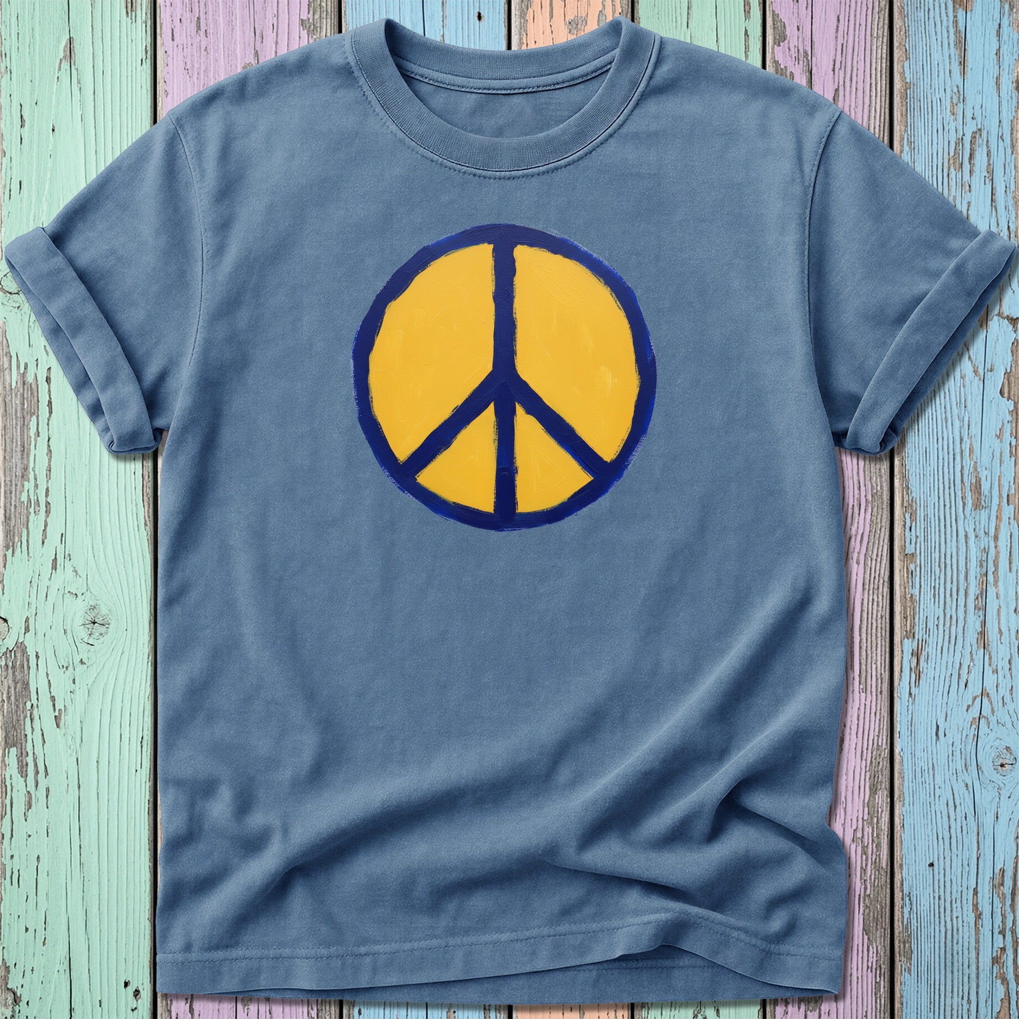 Blue t-shirt with a yellow and blue peace symbol graphic.