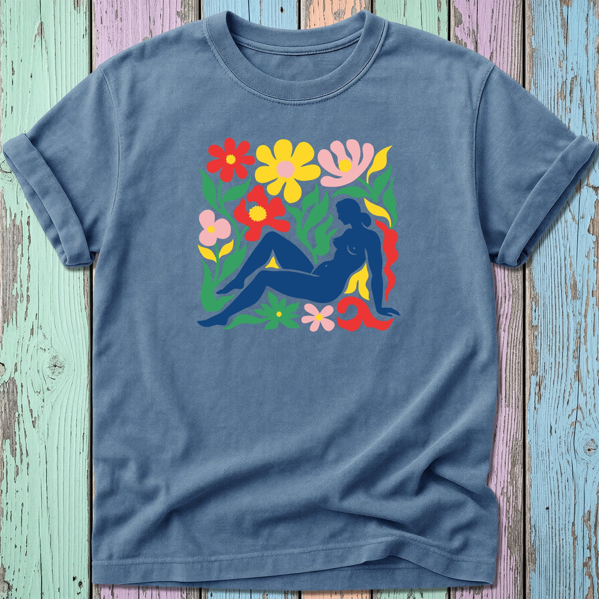 Blue t-shirt with colorful floral art featuring a reclining nude figure.