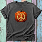 Dark t-shirt with a painted pumpkin featuring a glowing peace sign in the center.