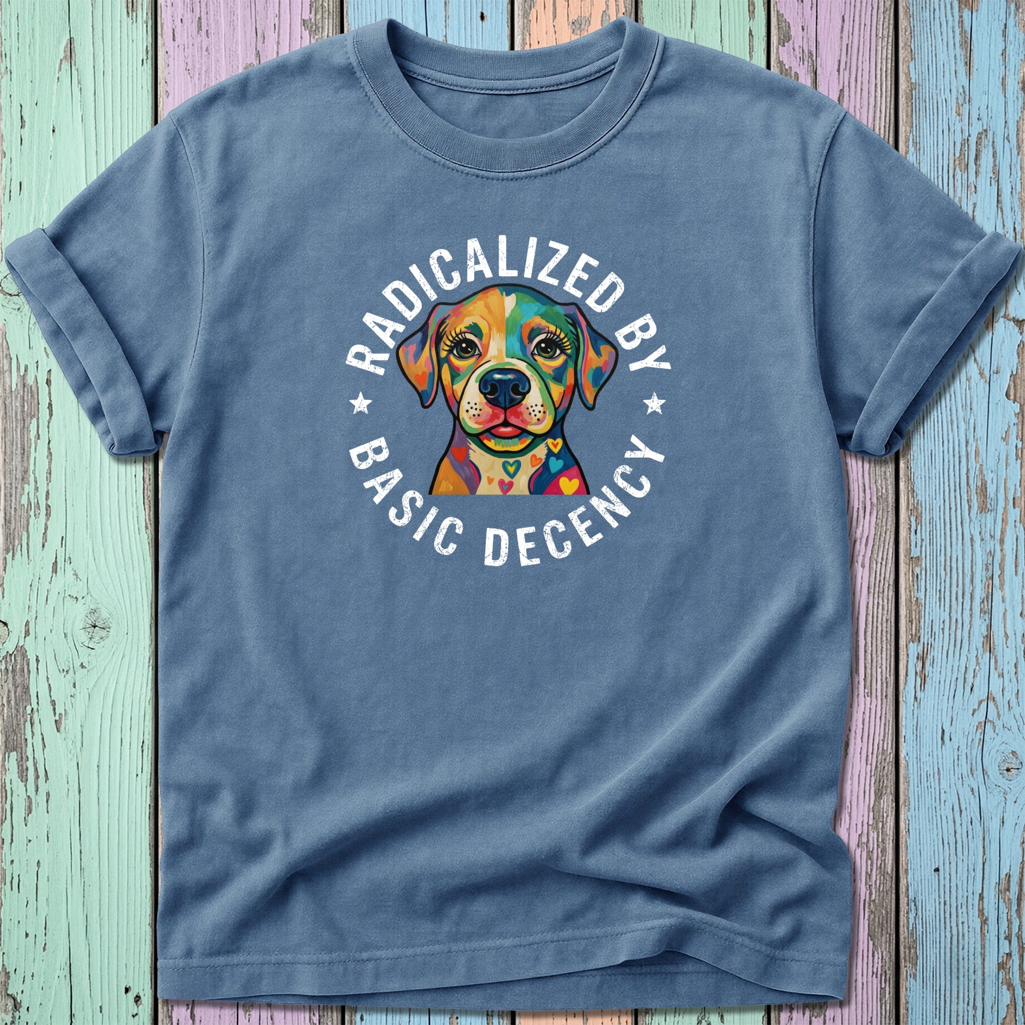 T-shirt with colorful dog graphic and text "RADICALIZED BY BASIC DECENCY".