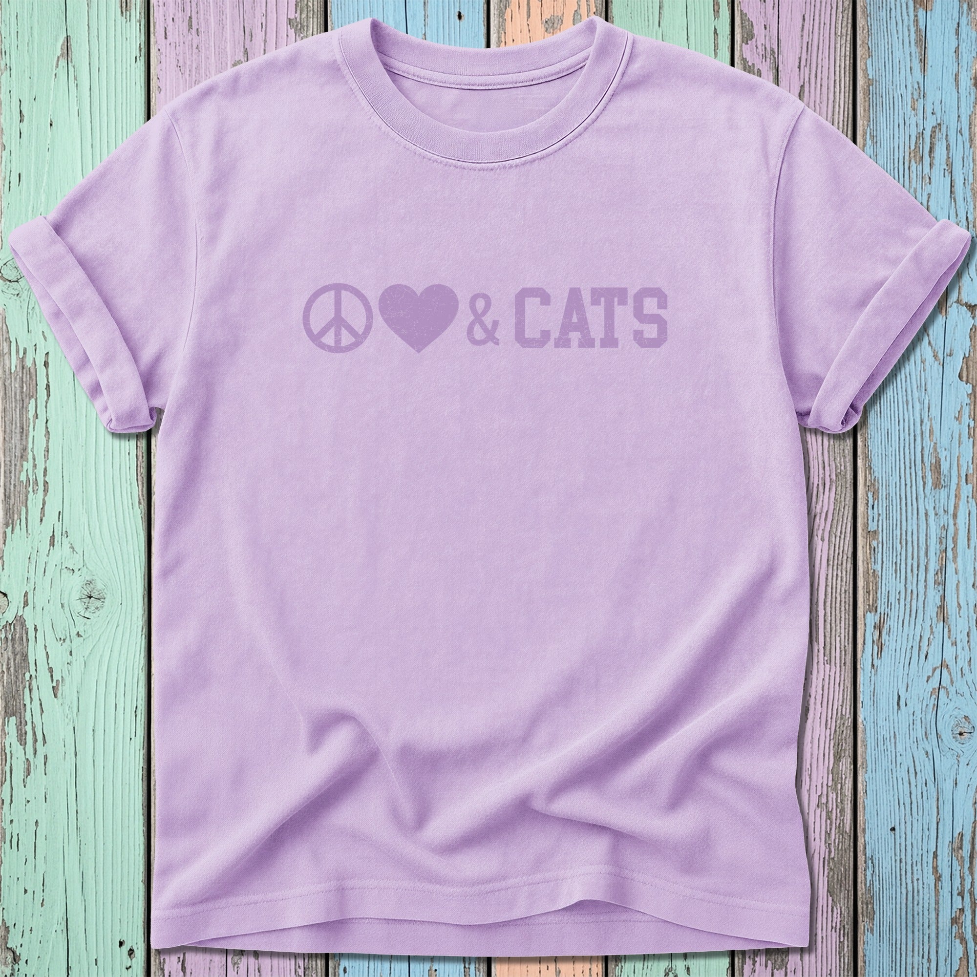 Purple t-shirt with peace symbol, heart, and "CATS" text.
