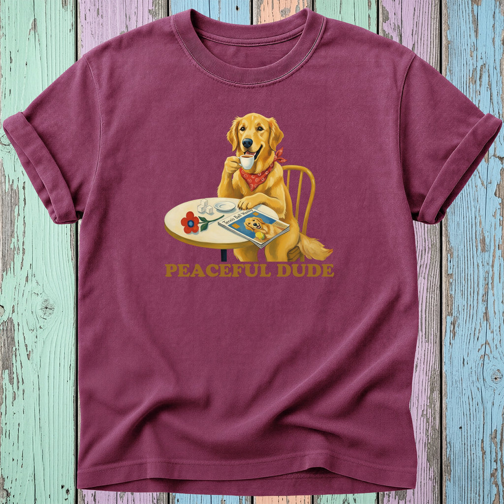Golden Retriever wearing a bandana drinks coffee at a table with a magazine.