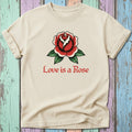 Cream t-shirt with a red rose tattoo design and "Love is a Rose" text.