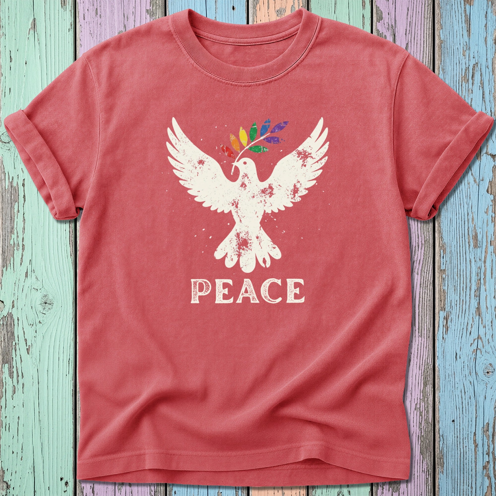 Red t-shirt with white dove holding a rainbow olive branch, text "PEACE".