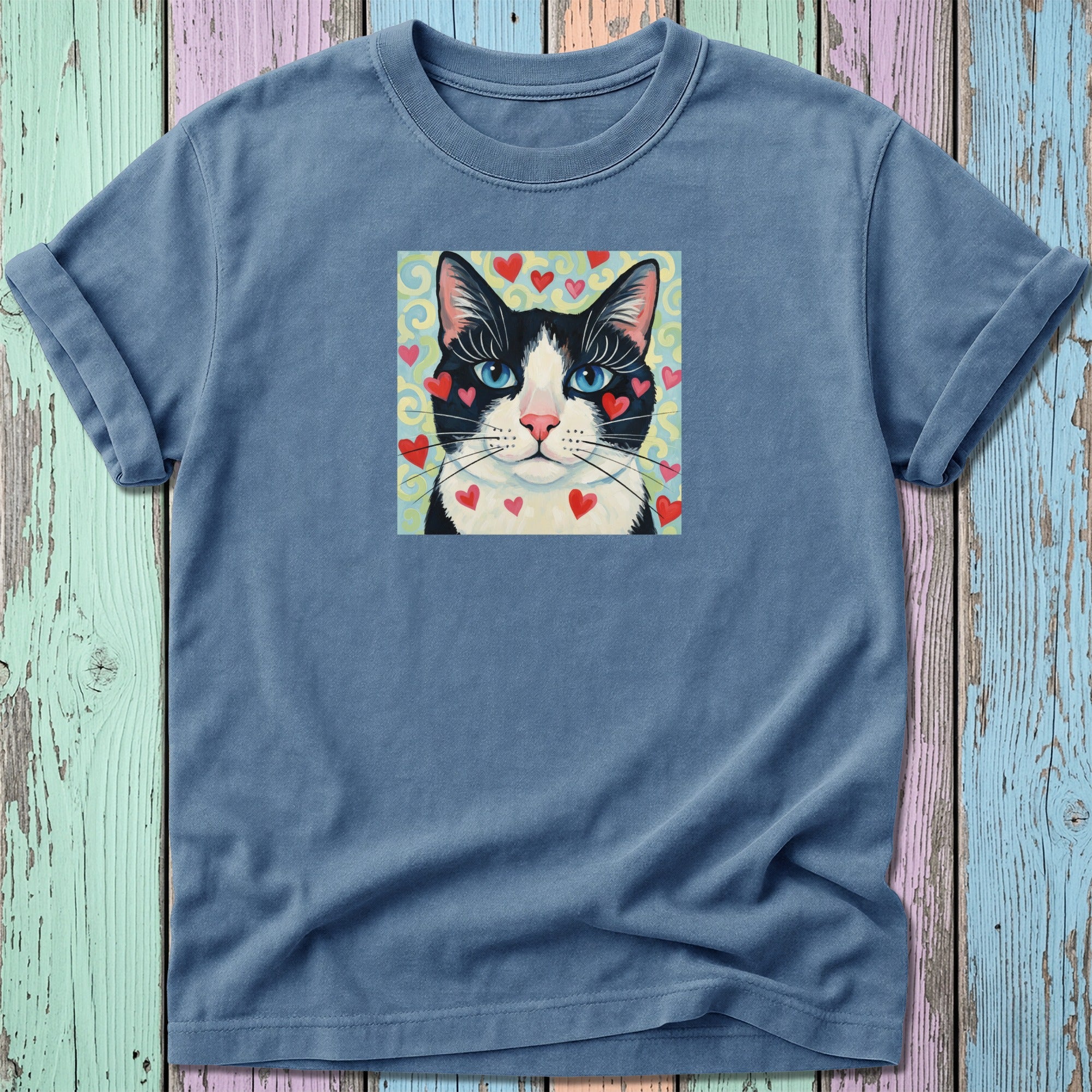 T-shirt with a black and white cat's face with pink hearts.