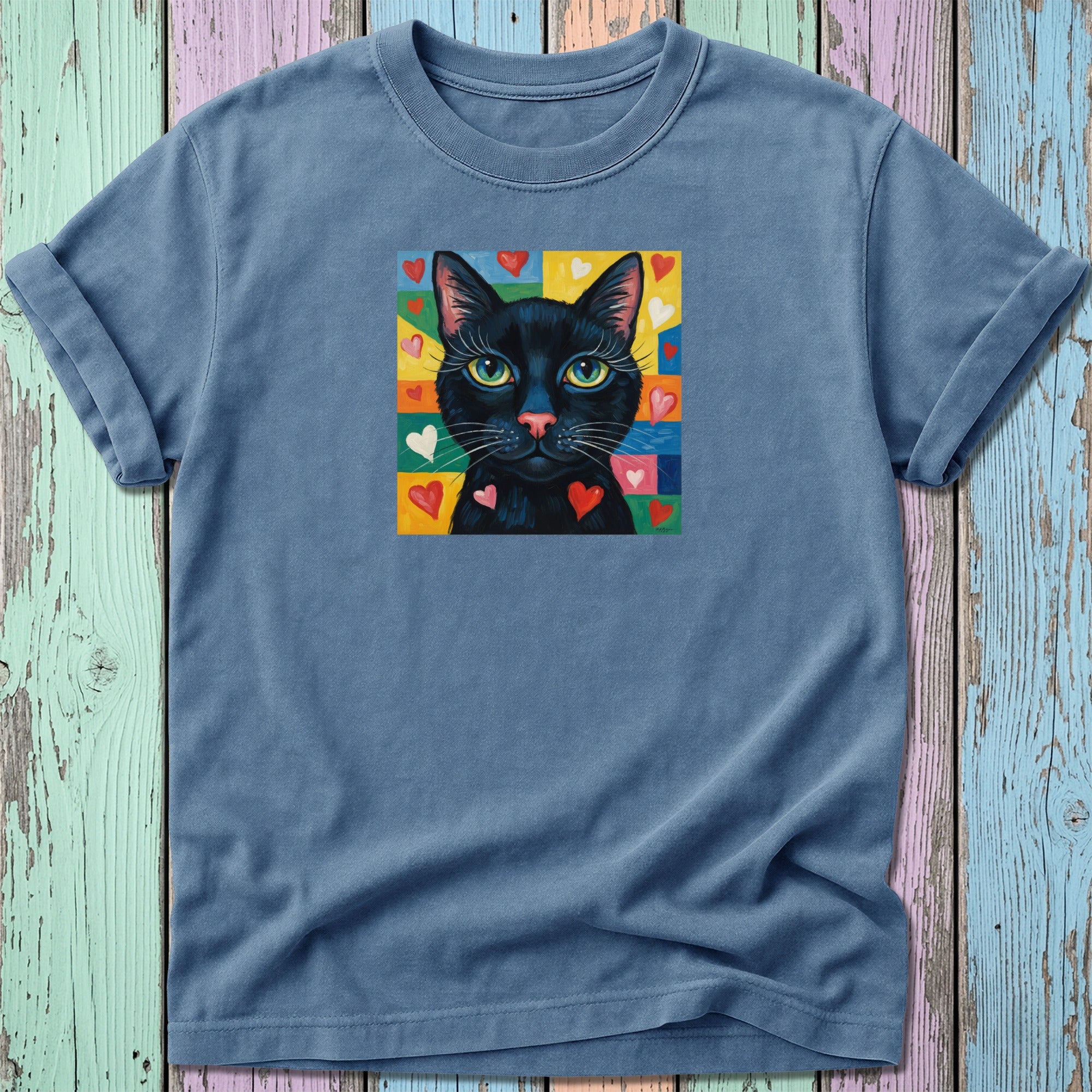 T-shirt with black cat and colorful heart pattern.