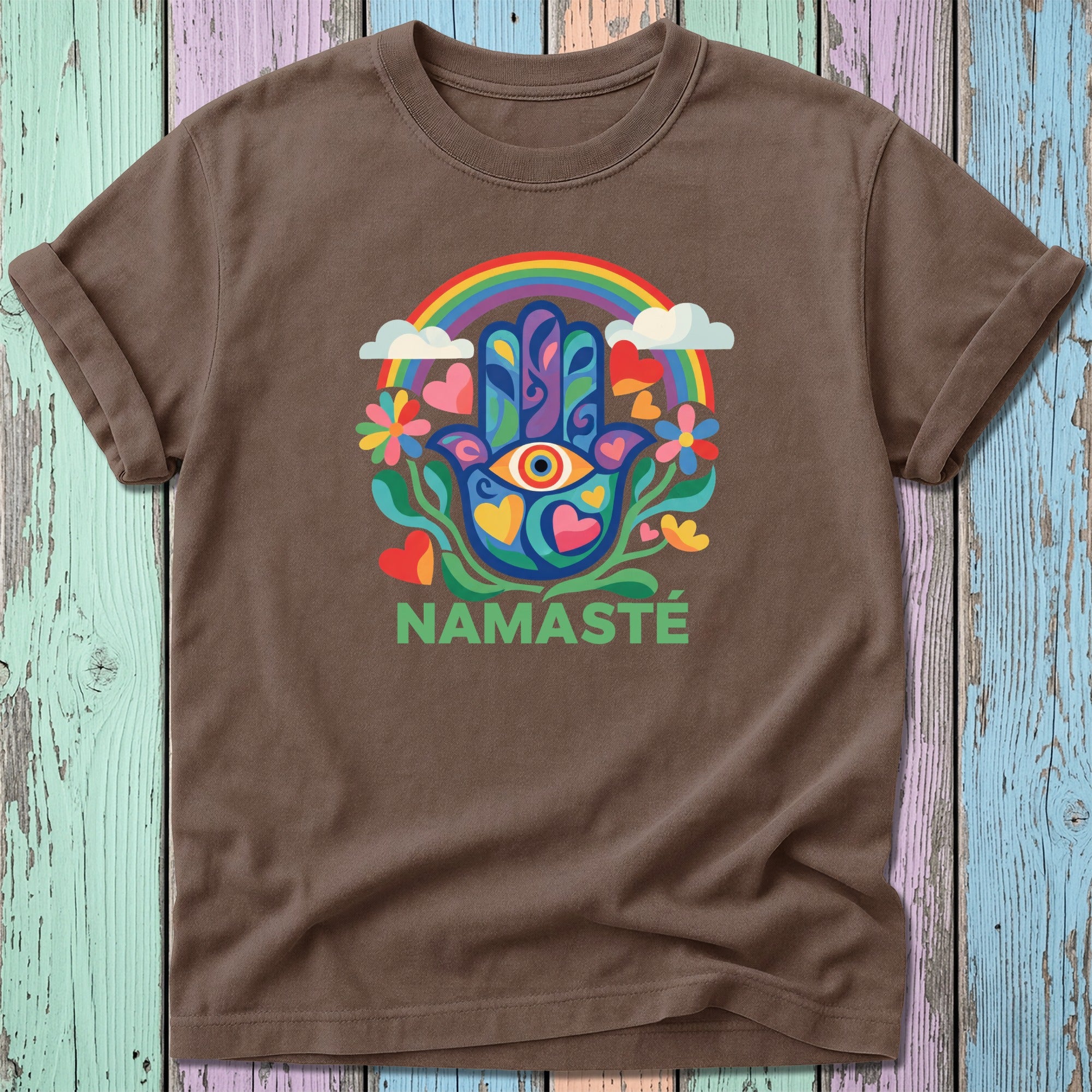 Brown t-shirt with colorful hamsa hand, rainbow, and "NAMASTÉ" text.