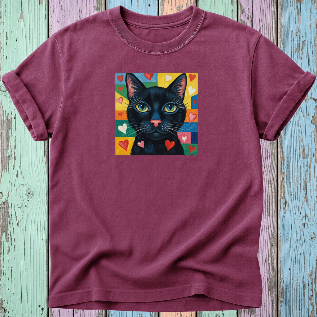 Maroon t-shirt with a black cat surrounded by colorful hearts.