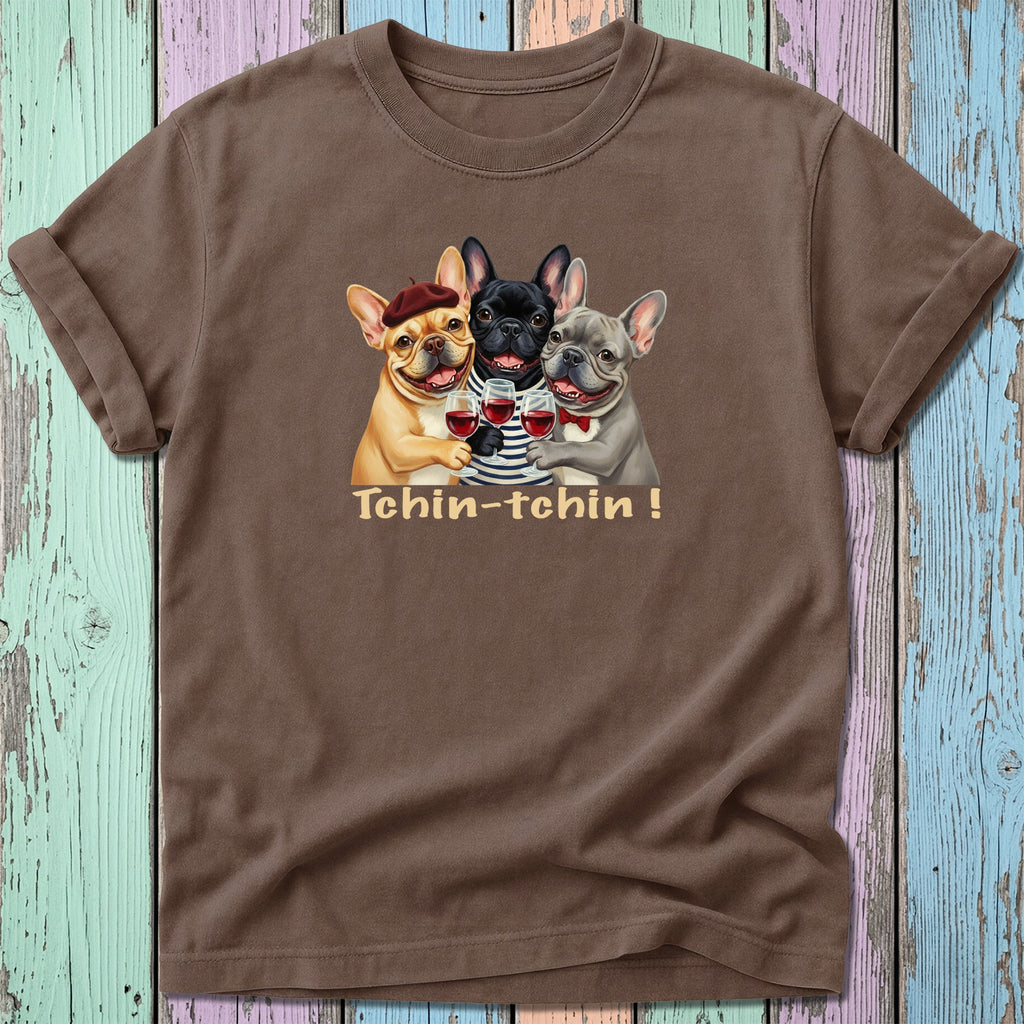 Three French bulldogs in berets and sweaters toast with wine glasses.