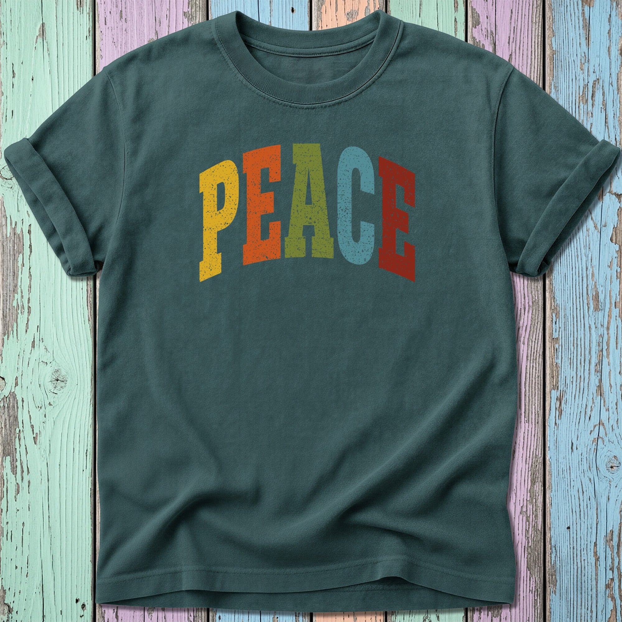 Dark green t-shirt with "PEACE" in colorful, distressed lettering.