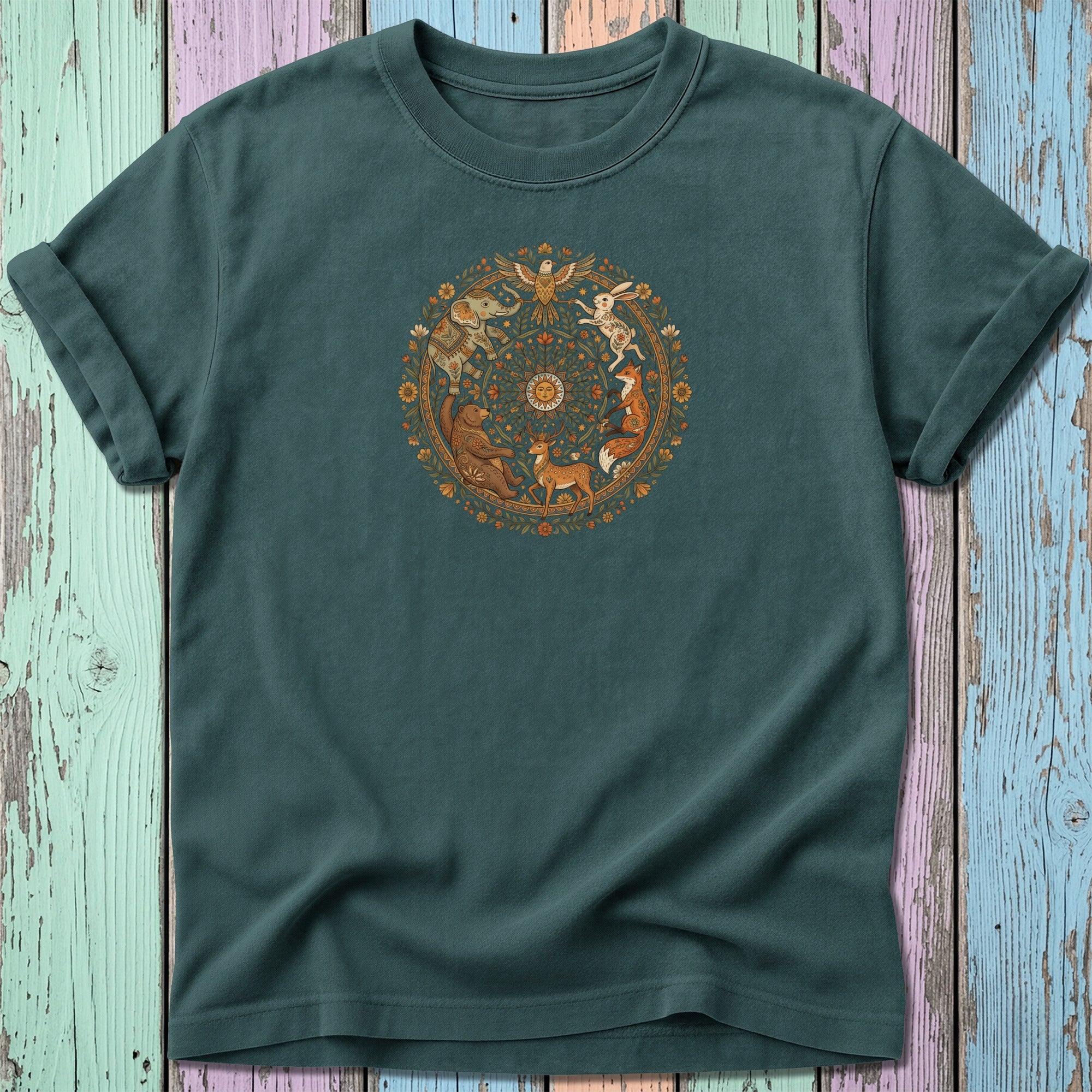 Green t-shirt with circular nature-themed animal illustration in cream and muted colors.