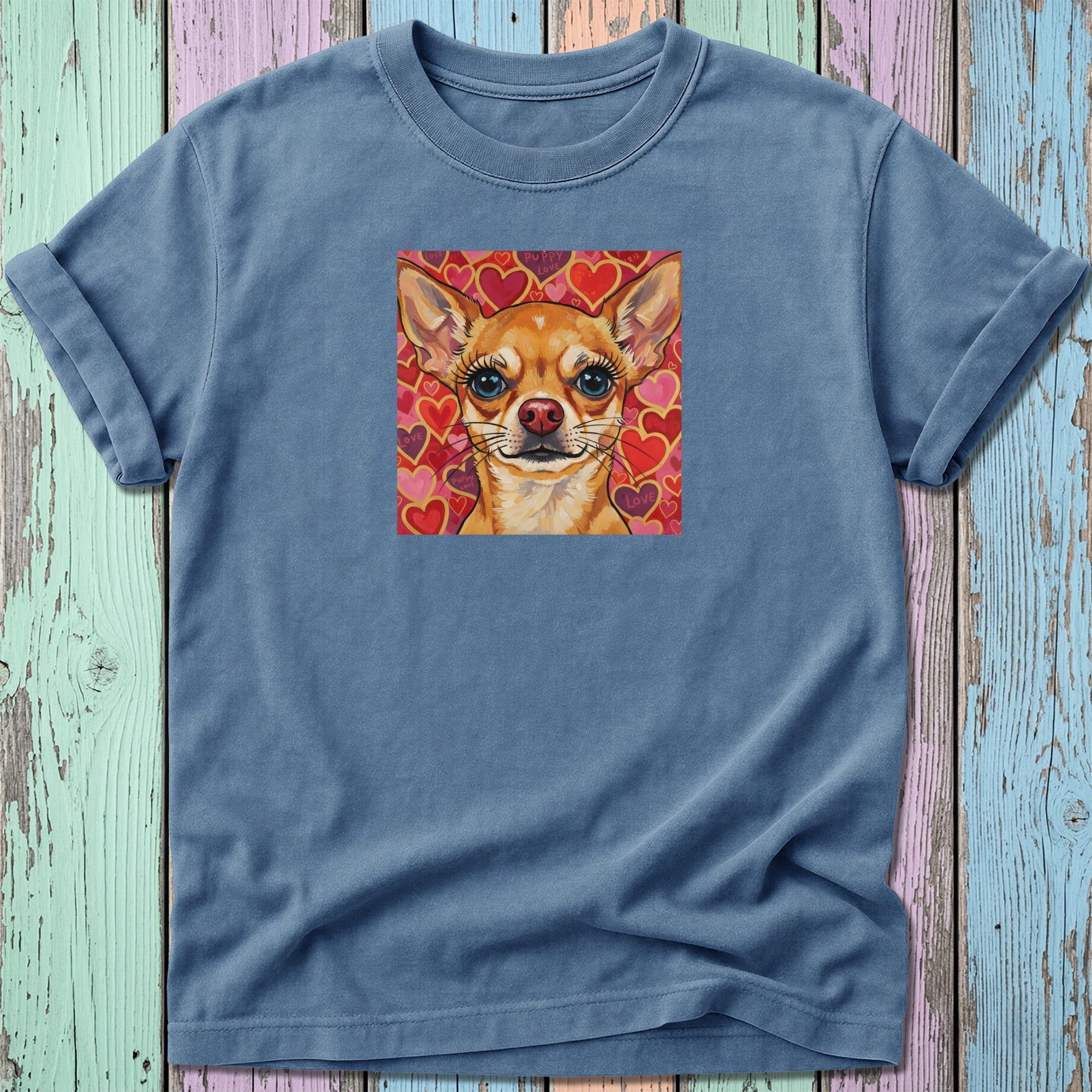 Blue t-shirt with a painting of a chihuahua wearing a heart collar.