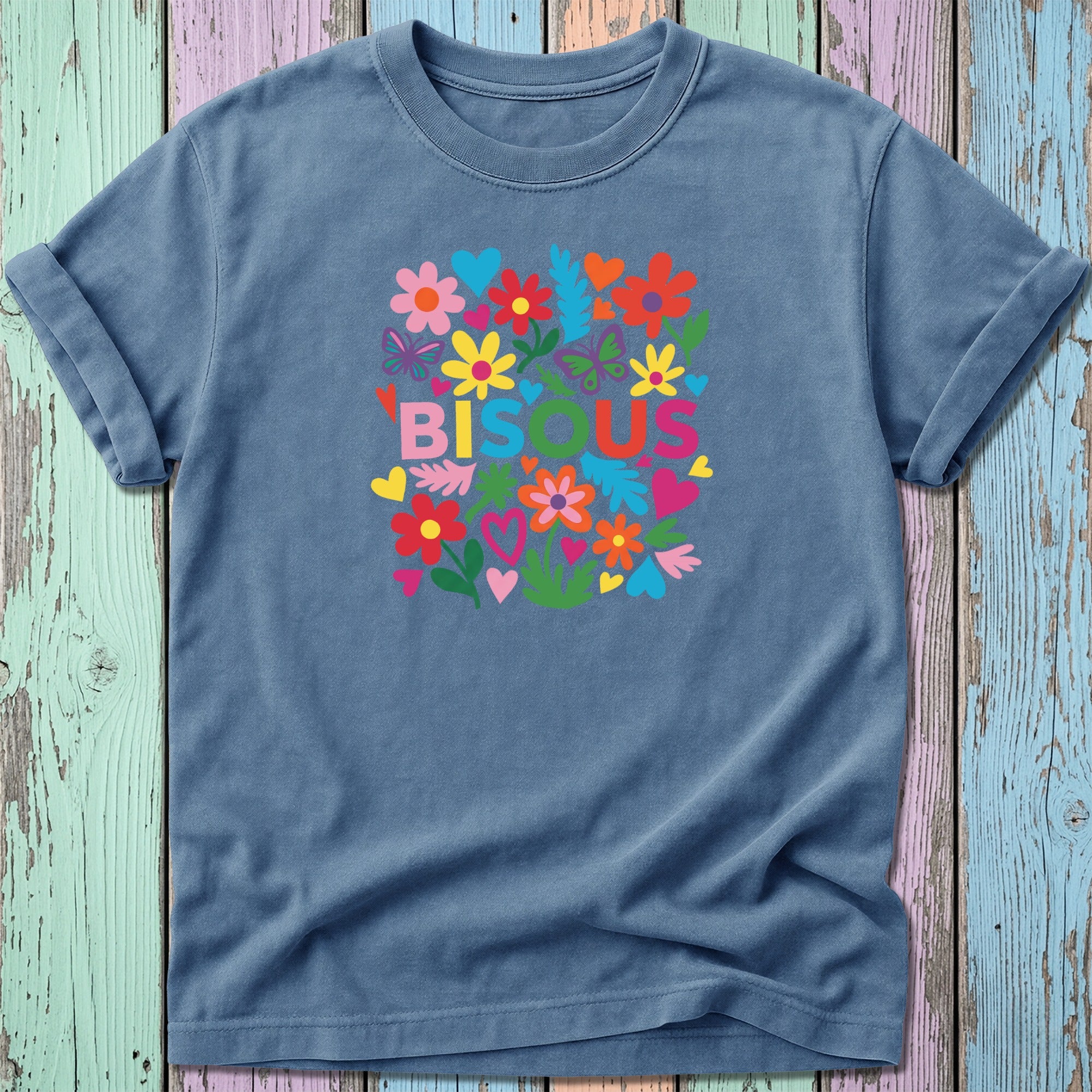 Blue t-shirt with colorful floral design and "BISOU" text.
