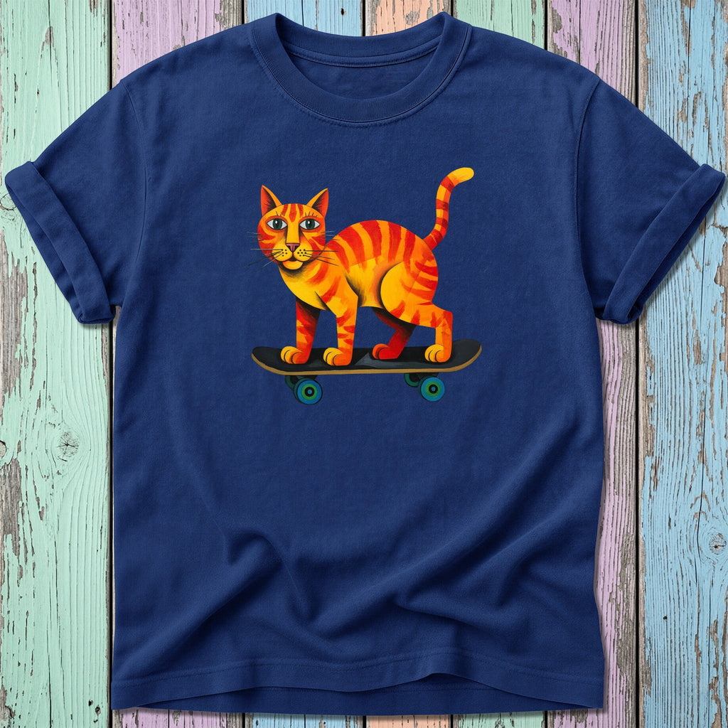 Orange tabby cat with stripes riding a skateboard on a navy t-shirt.