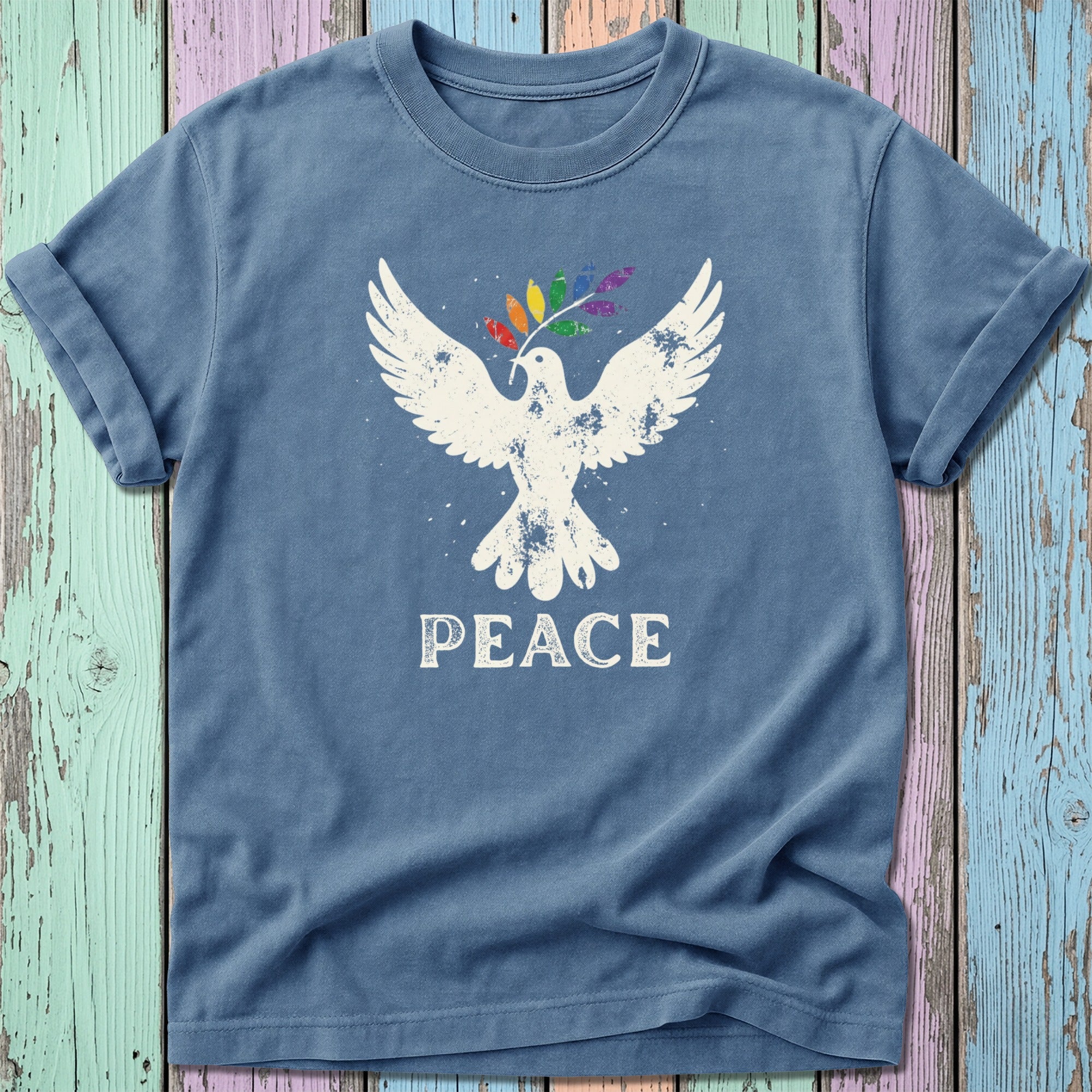 Blue t-shirt with white dove holding rainbow peace branch, "PEACE" text.