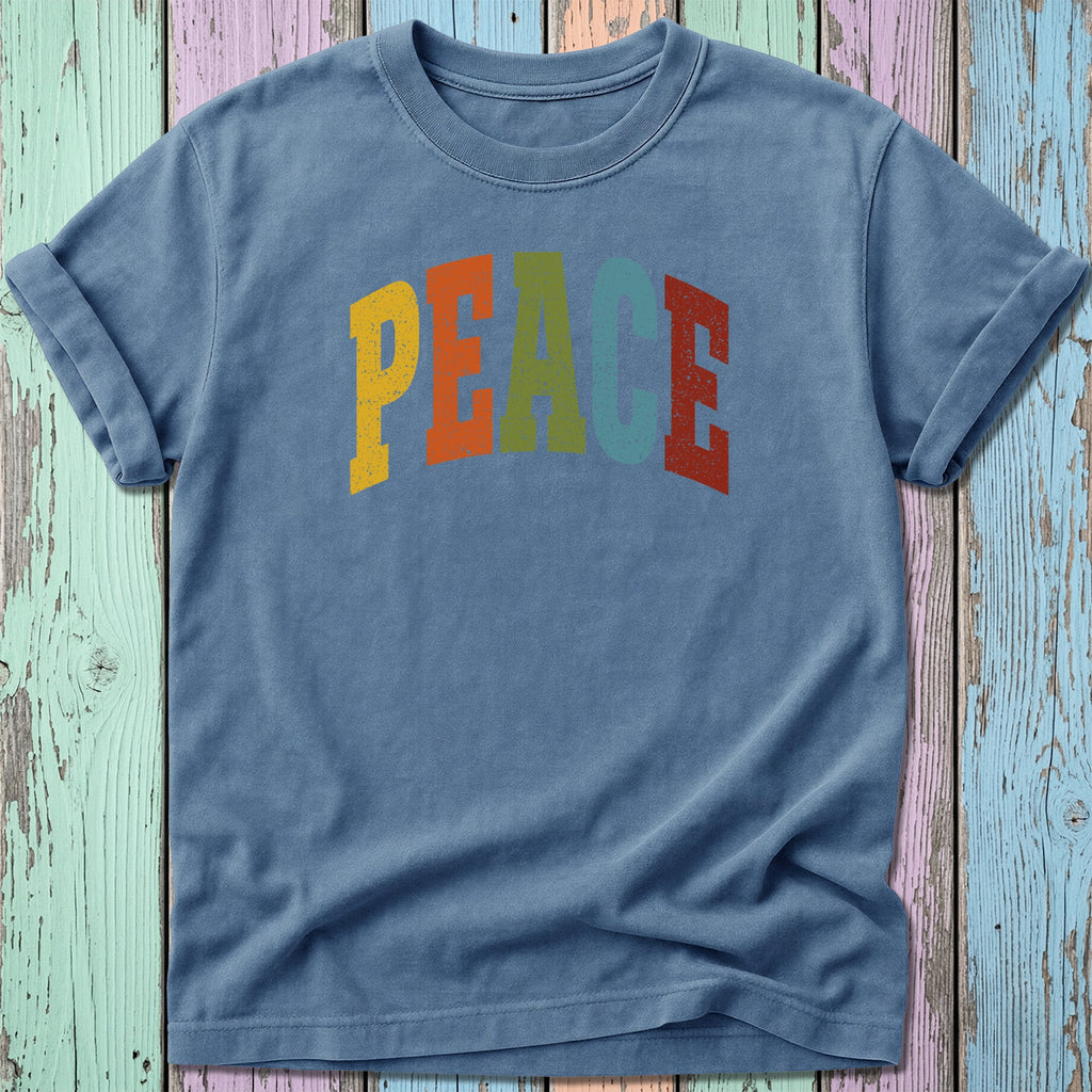 Blue t-shirt with arched "PEACE" graphic in colorful block letters.