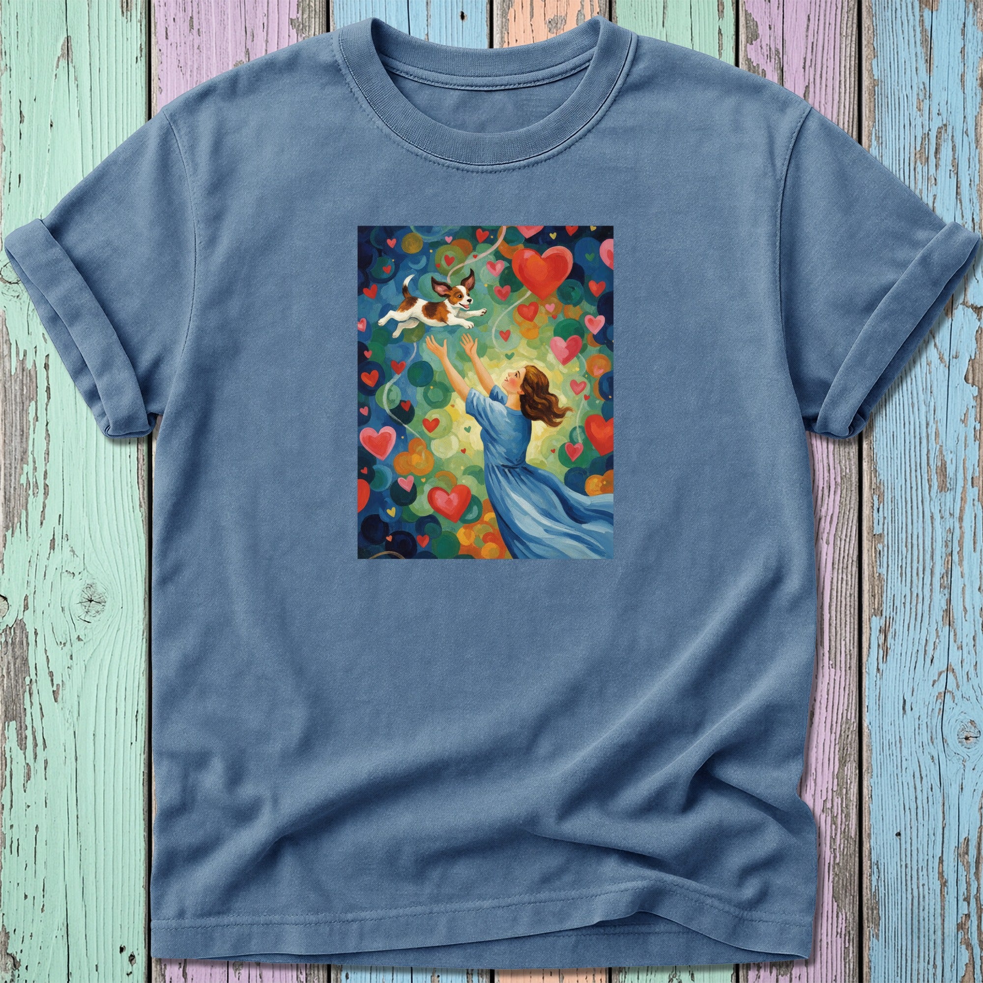 Woman in blue dress reaching for a dog among colorful hearts.
