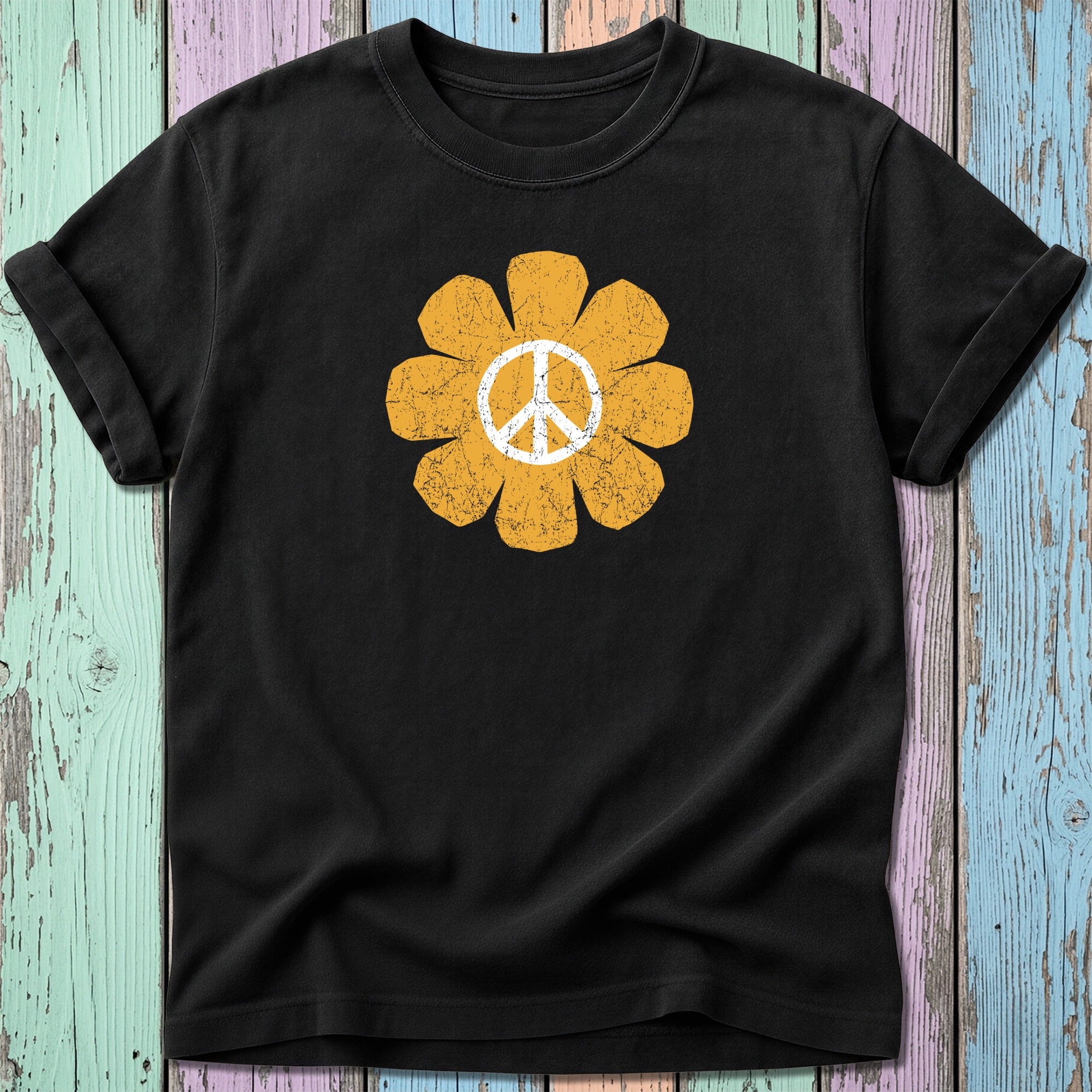 Black t-shirt with a distressed yellow peace sign flower graphic.