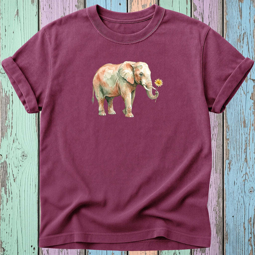 Watercolor elephant holding a yellow flower on a burgundy t-shirt.