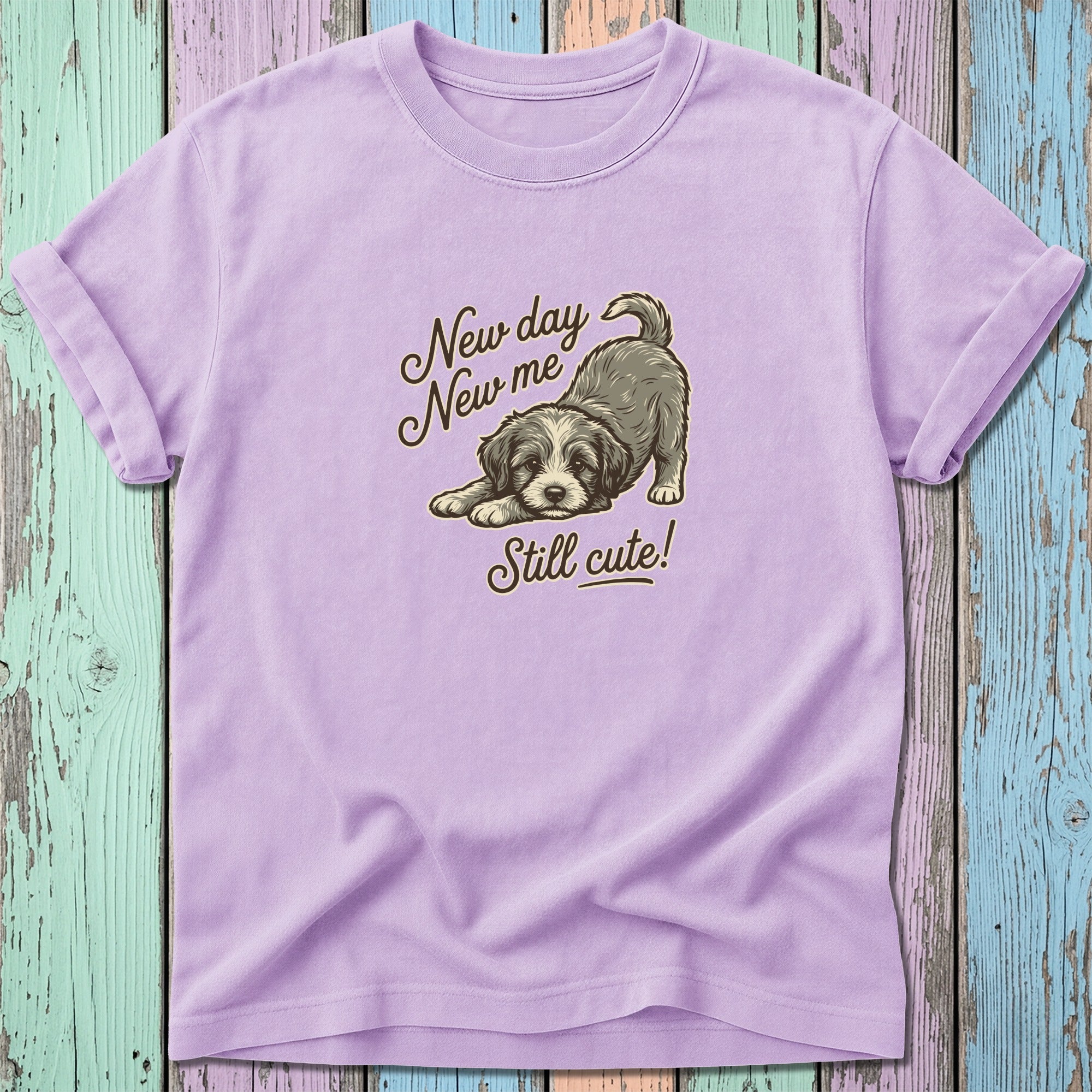 Levender t-shirt with a dog graphic and text "New day New me Still cute!"