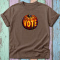 Brown t-shirt with a colorful, stylized pumpkin graphic that says "VOTE".