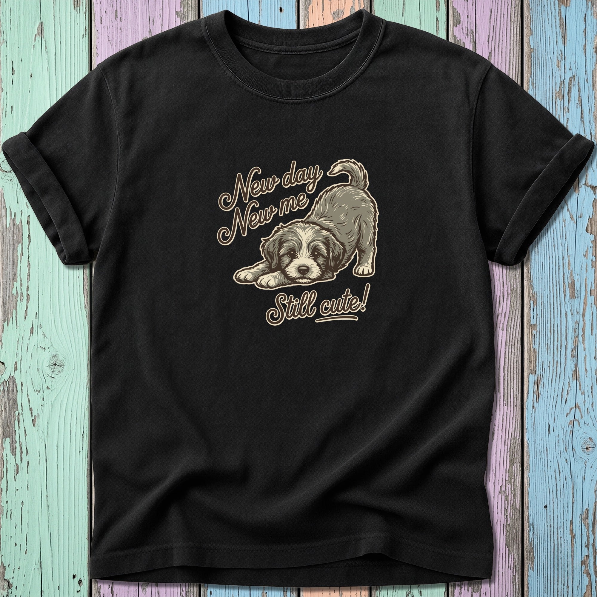 Black t-shirt with a drawing of a puppy and text "New day New me Still cute!".
