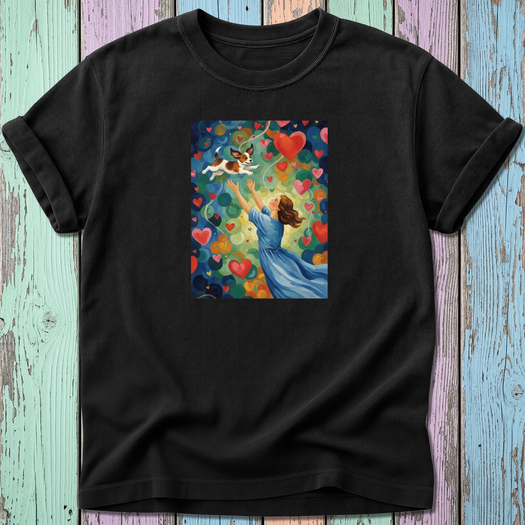 Woman in blue dress with dog and hearts, colorful heart art on black t-shirt.