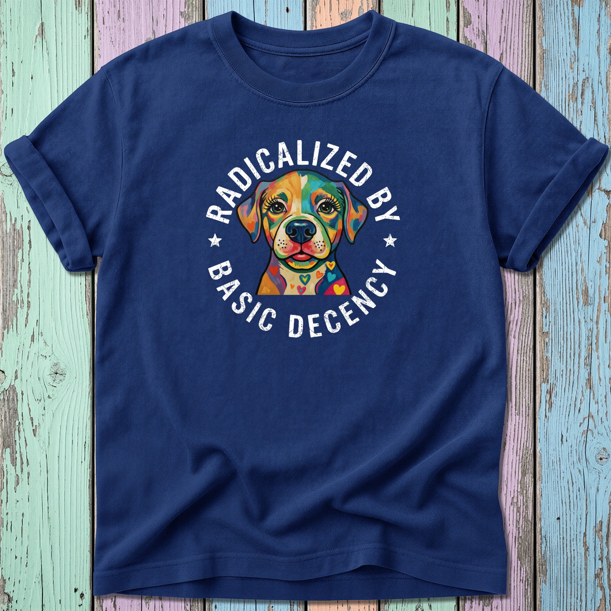 Navy t-shirt with colorful dog wearing a heart-shaped collar, text "RADICALIZED BY BASIC DECENCY".