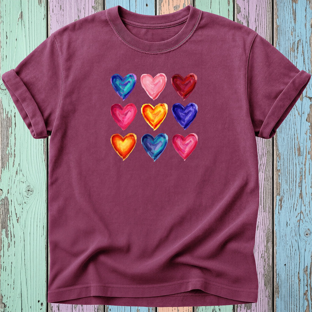T-shirt with nine colorful watercolor heart designs in a grid.