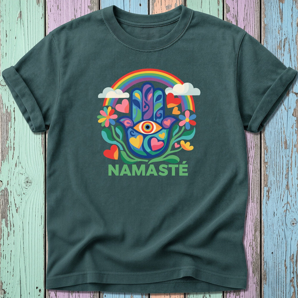 Namaste t-shirt with rainbow, eye, and floral design on a wooden background.