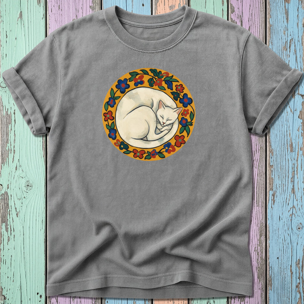 White cat sleeping in a floral wreath on a gray t-shirt.