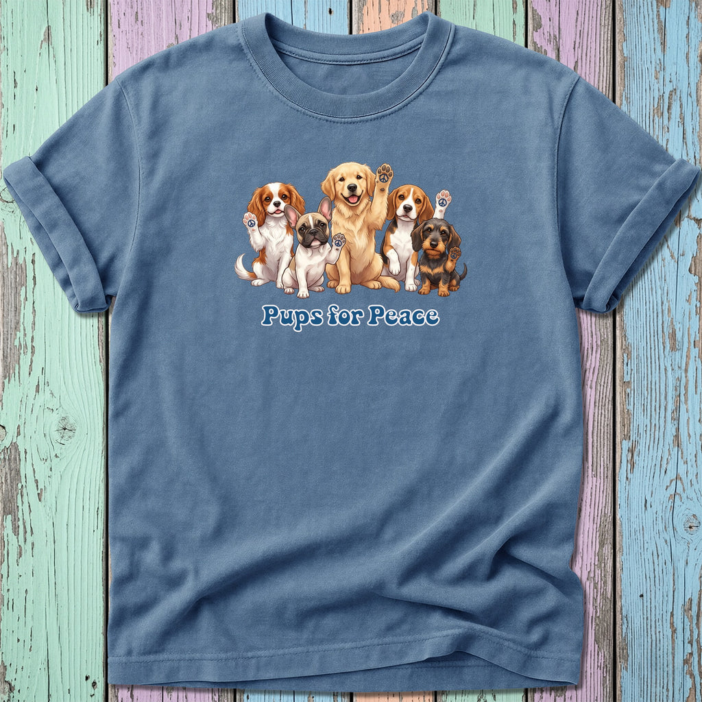 Group of dogs with "Pups for Peace" text on a blue t-shirt.