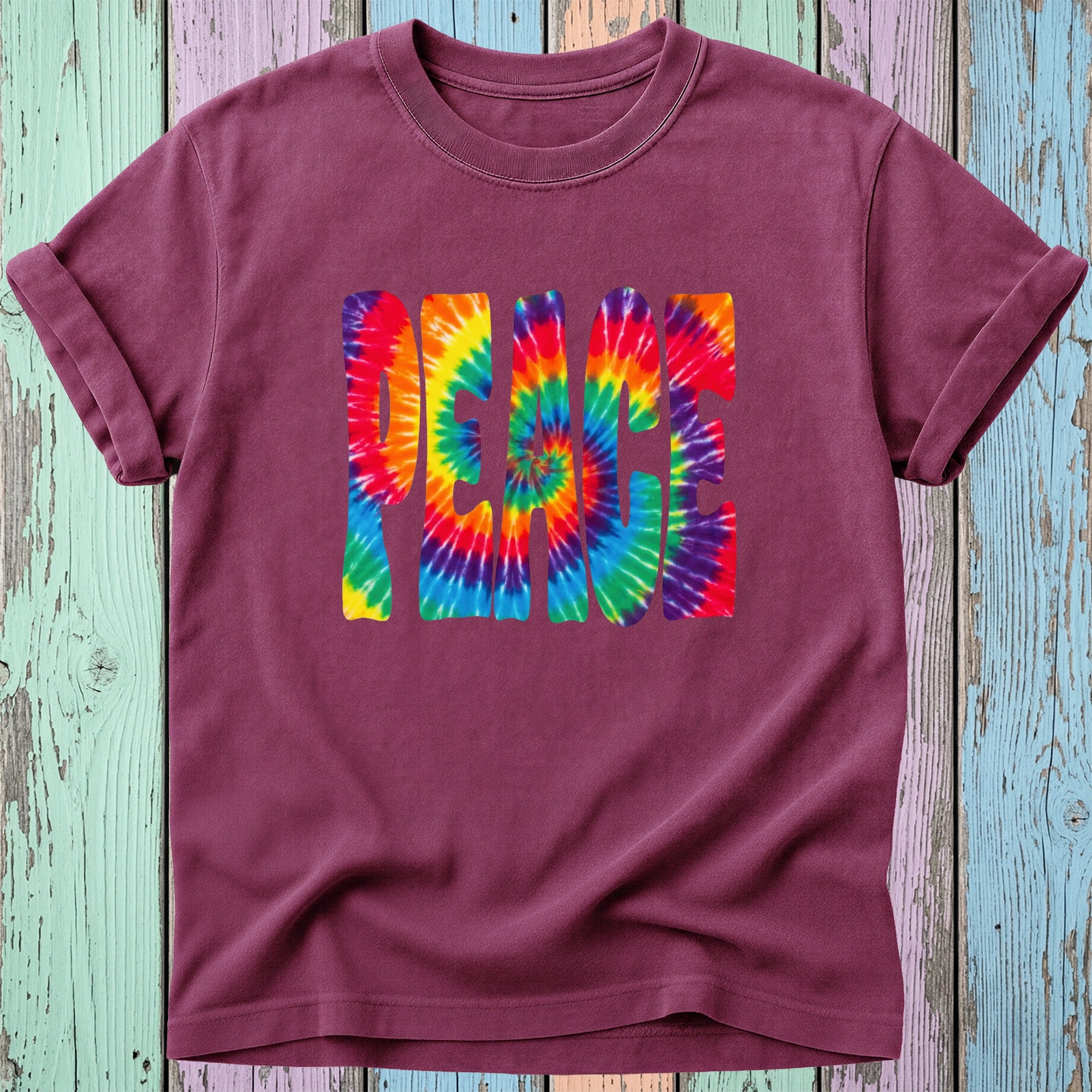 Maroon t-shirt with "PEACE" in a rainbow tie-dye spiral design.