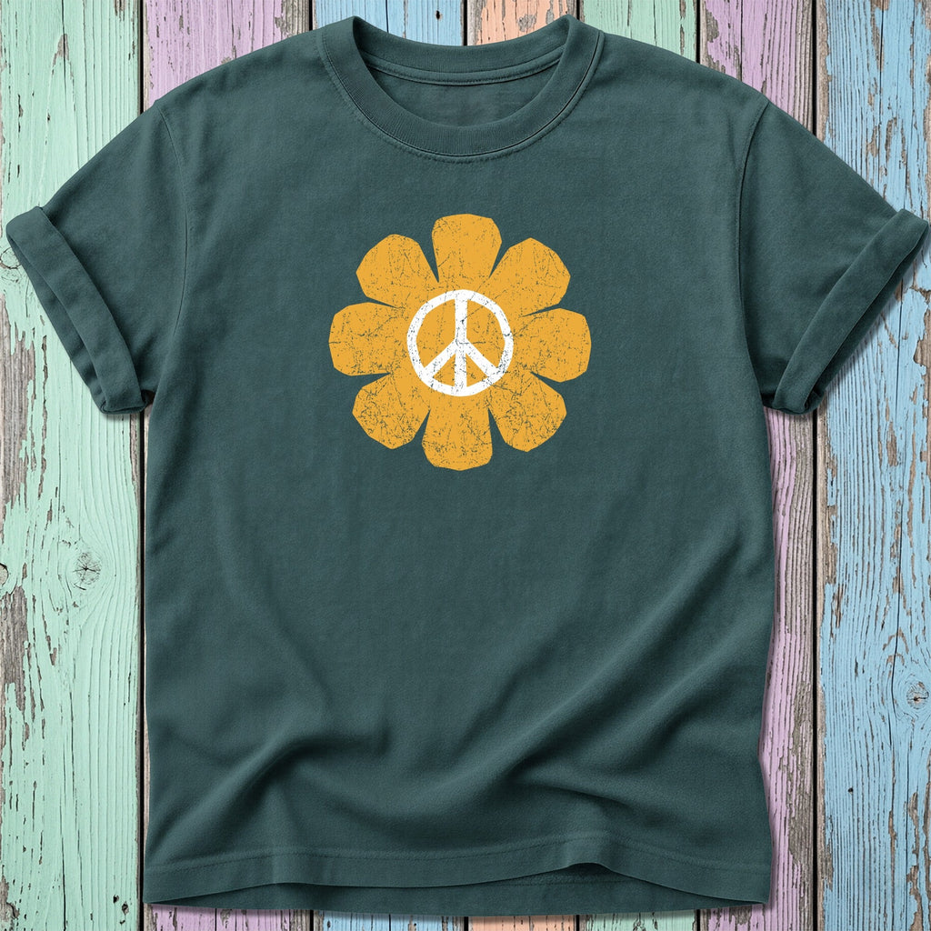 Green t-shirt with a distressed yellow peace sign flower graphic.