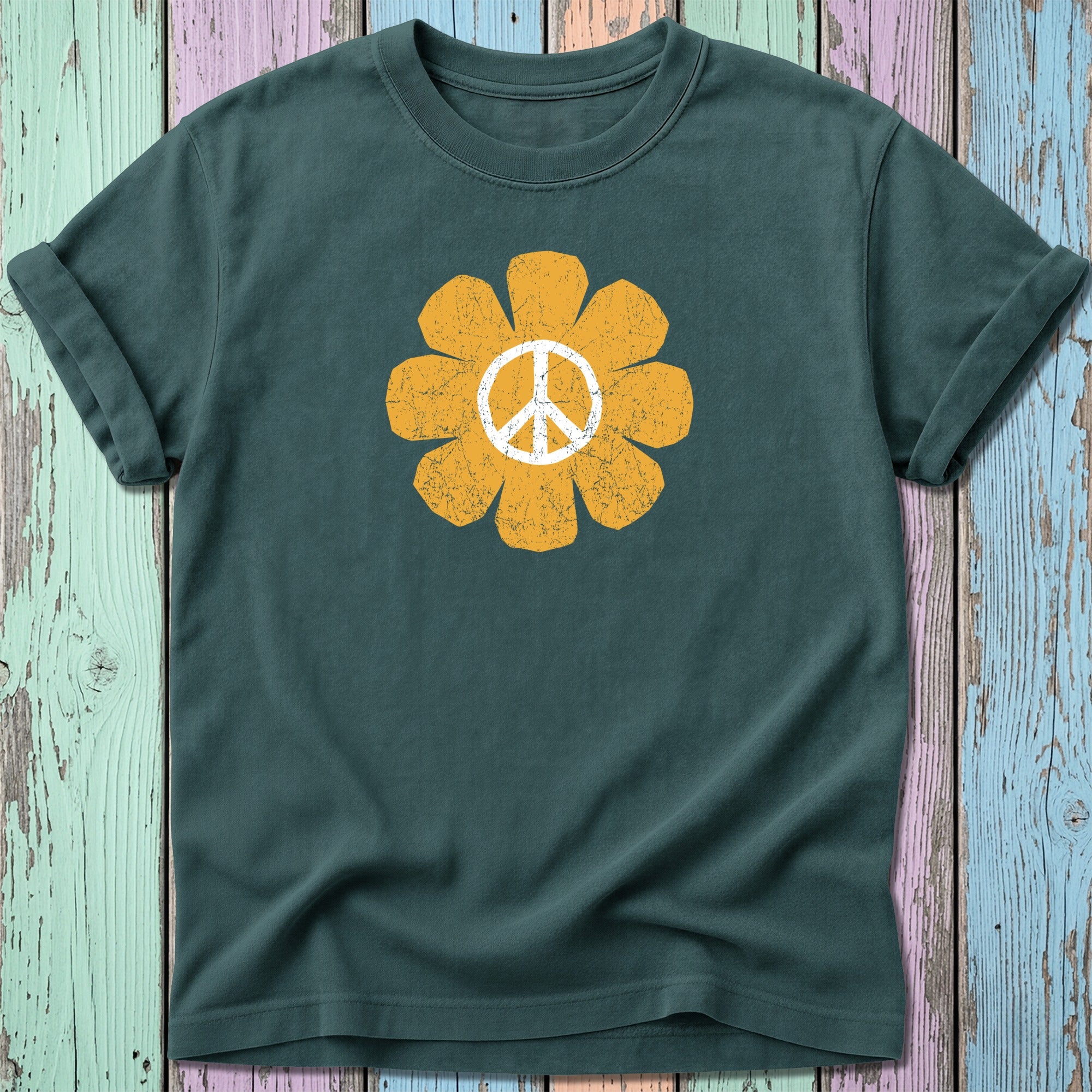 Green t-shirt with a distressed yellow peace sign flower graphic.